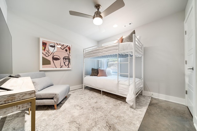 bedroom with concrete flooring, visible vents, baseboards, and a ceiling fan