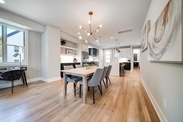 dining area with baseboards, visible vents, an inviting chandelier, light wood-type flooring, and recessed lighting