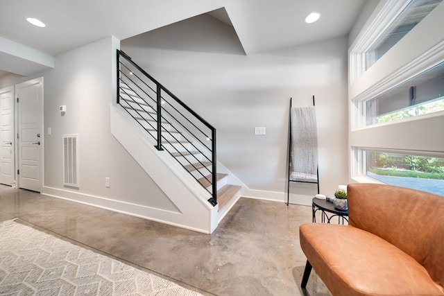 stairs featuring baseboards, recessed lighting, visible vents, and finished concrete floors