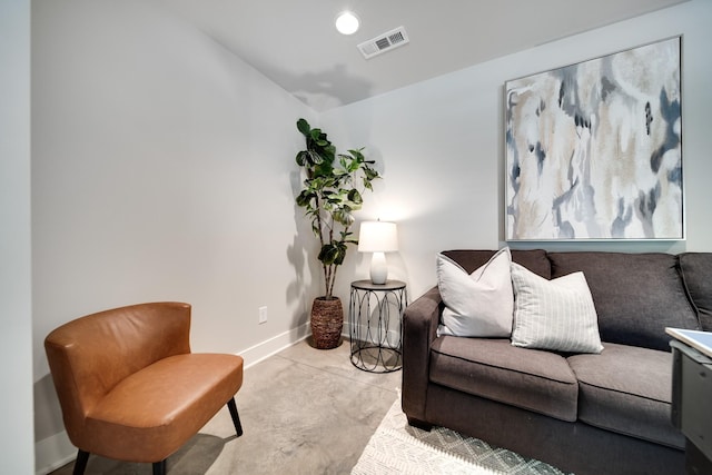 living room with concrete floors, recessed lighting, visible vents, and baseboards