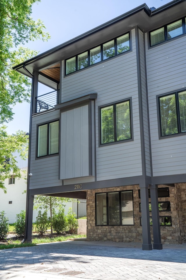 back of house with stone siding