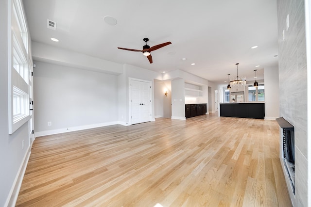 unfurnished living room featuring light wood-type flooring, ceiling fan, visible vents, and recessed lighting