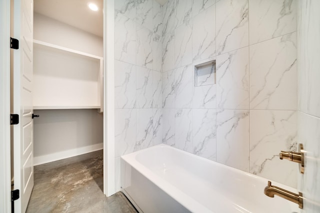 full bath featuring concrete flooring and a bathing tub