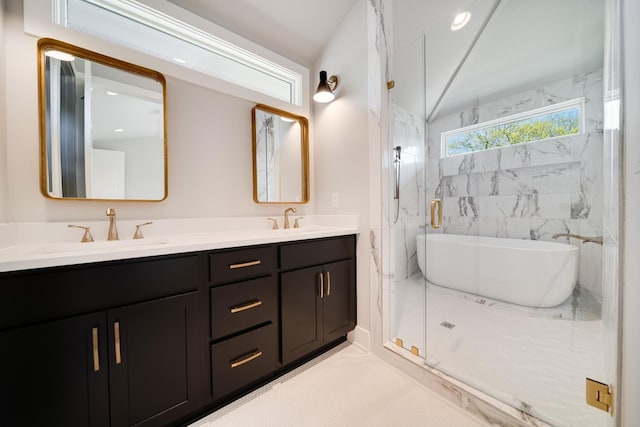 bathroom with double vanity, a freestanding tub, a sink, and a marble finish shower