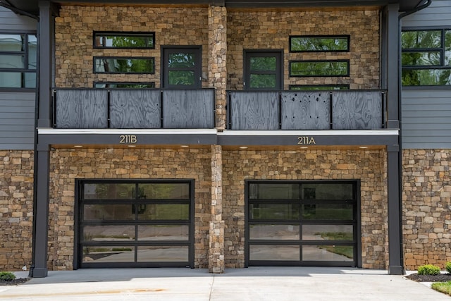 entrance to property featuring driveway and a balcony