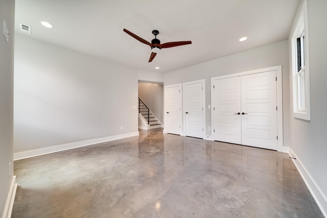 unfurnished bedroom with multiple closets, recessed lighting, finished concrete floors, a ceiling fan, and baseboards