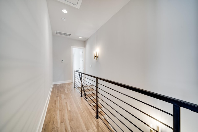 hall featuring recessed lighting, visible vents, an upstairs landing, light wood-type flooring, and baseboards