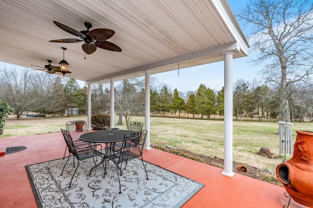 view of patio with a ceiling fan and outdoor dining area