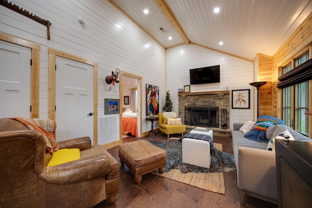 living room featuring wood finished floors, beamed ceiling, wood walls, a fireplace, and high vaulted ceiling