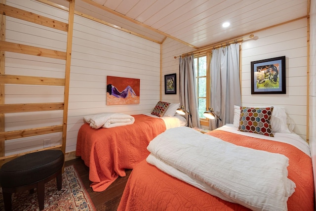 bedroom featuring wooden ceiling and wooden walls