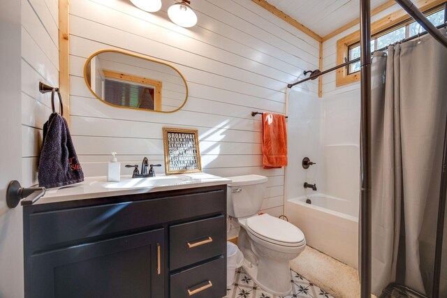 bathroom with shower / tub combo, vanity, toilet, and wooden walls