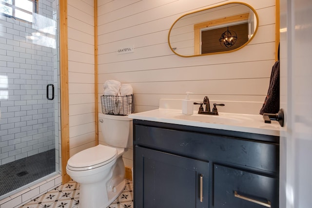 bathroom featuring toilet, a shower stall, and vanity