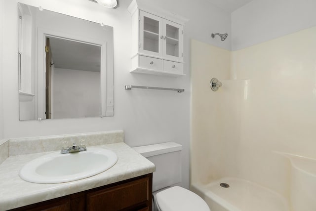 full bathroom featuring vanity, toilet, and walk in shower