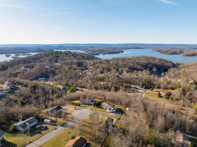 bird's eye view with a forest view and a water view