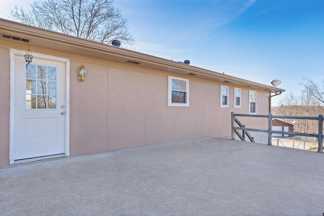 back of property featuring a patio area and visible vents