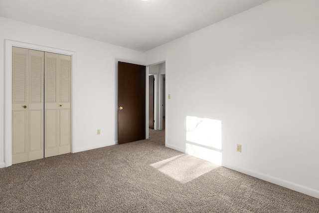 unfurnished bedroom featuring carpet floors and a closet