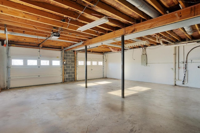 garage with electric panel and a garage door opener