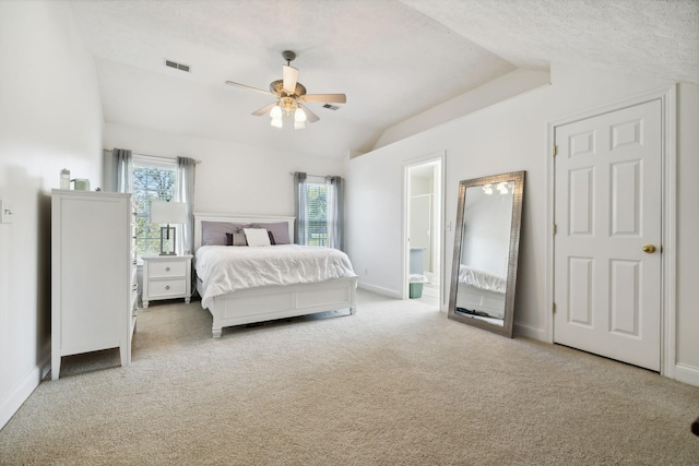 bedroom with carpet floors, visible vents, vaulted ceiling, and baseboards