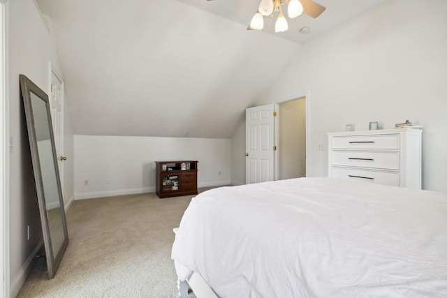 bedroom featuring light carpet, lofted ceiling, a ceiling fan, and baseboards