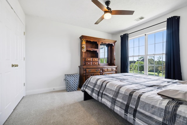 bedroom with a ceiling fan, carpet, visible vents, and baseboards