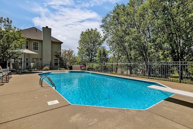 view of swimming pool with fence, a fenced in pool, and a patio