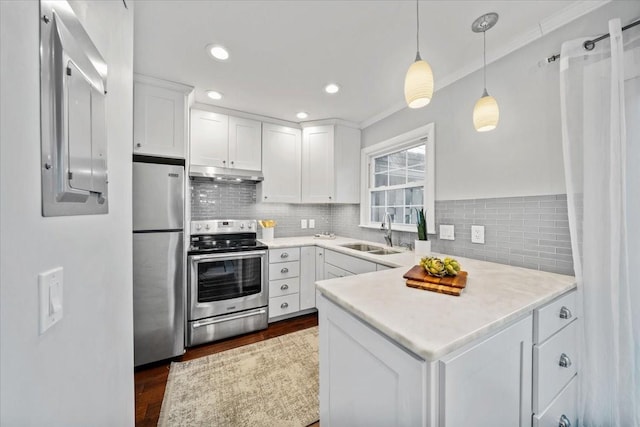 kitchen featuring stainless steel appliances, light countertops, white cabinets, a sink, and under cabinet range hood