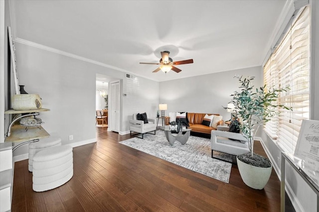 living room with baseboards, visible vents, ceiling fan, dark wood-type flooring, and crown molding