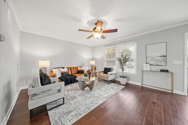 living area with a ceiling fan, crown molding, dark wood finished floors, and baseboards