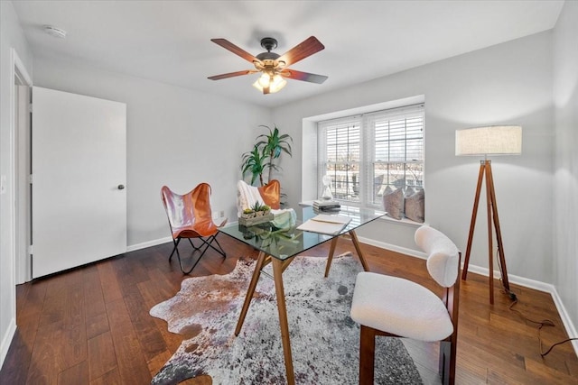 office area featuring a ceiling fan, baseboards, and hardwood / wood-style flooring