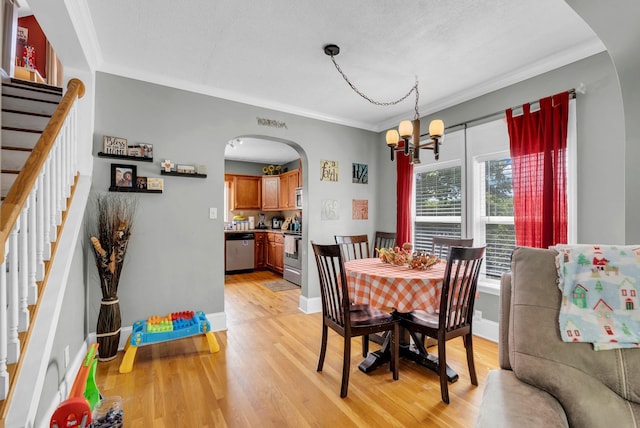 dining room with arched walkways, ornamental molding, and stairway