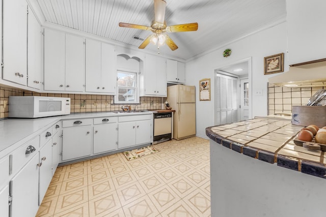 kitchen featuring tile counters, white appliances, white cabinetry, and backsplash