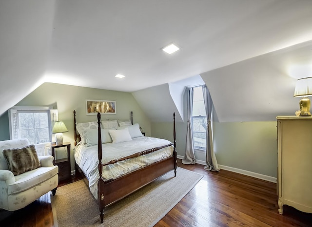 bedroom with lofted ceiling, baseboards, and wood finished floors