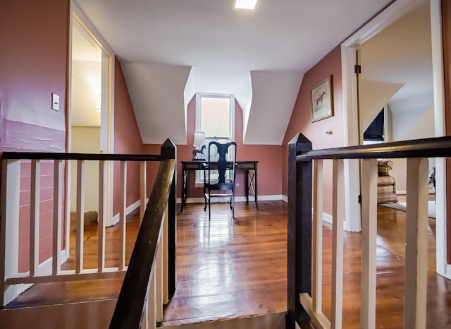 bonus room featuring lofted ceiling, baseboards, and wood finished floors