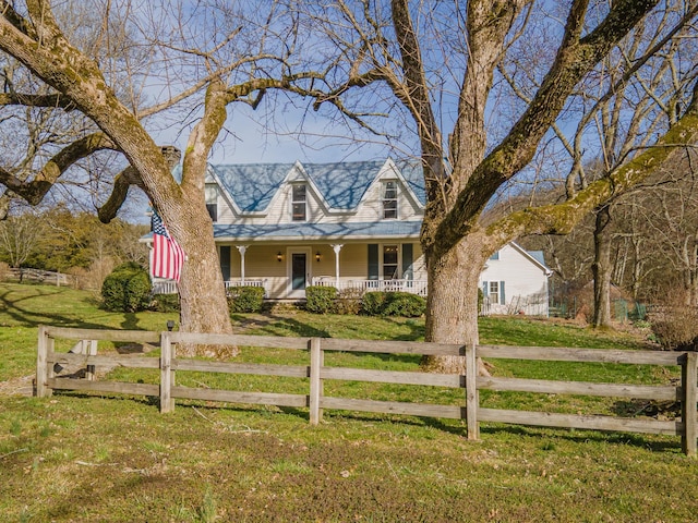 view of front of home with covered porch, a fenced front yard, and a front yard