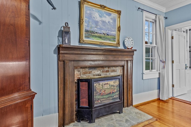 room details with a fireplace, crown molding, and wood finished floors