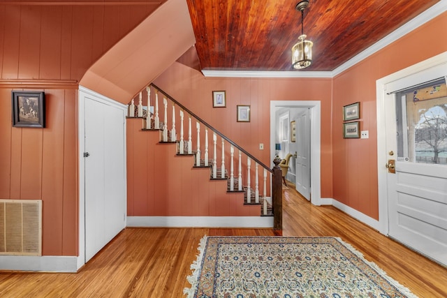 entryway with baseboards, visible vents, wooden ceiling, stairway, and wood finished floors