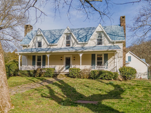 farmhouse-style home featuring covered porch, a chimney, and a front lawn