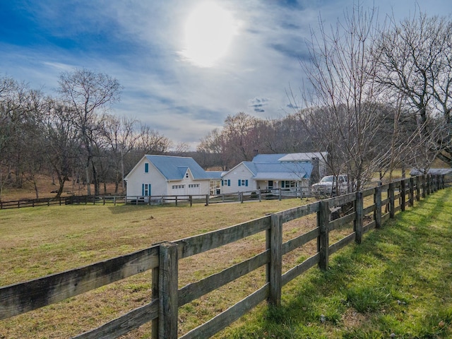 view of yard with a rural view and fence