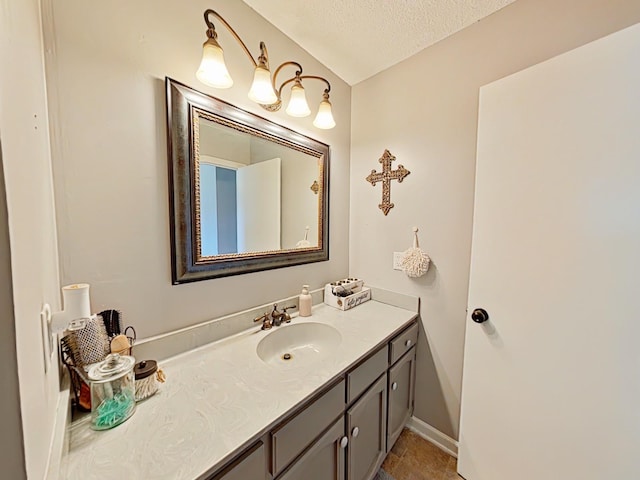 bathroom featuring a textured ceiling and vanity