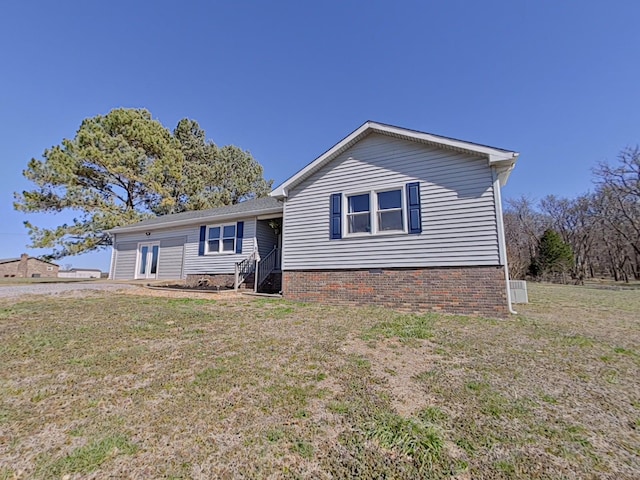 rear view of property featuring a yard