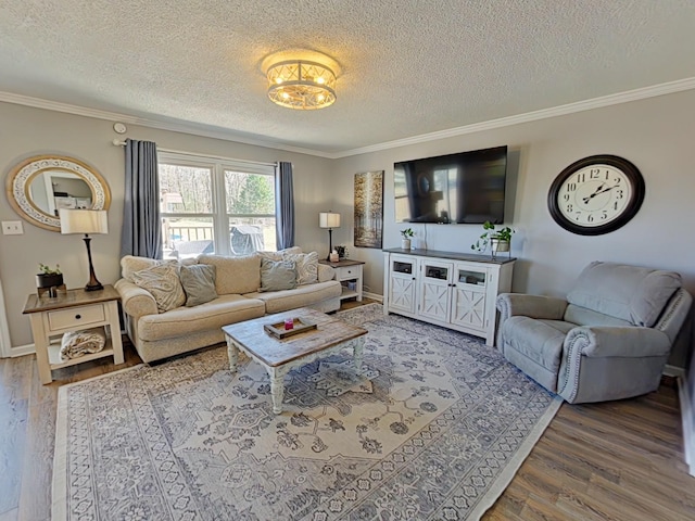 living room featuring ornamental molding, a textured ceiling, baseboards, and wood finished floors