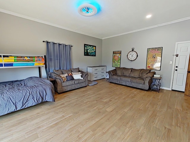 living area with baseboards, wood finished floors, and crown molding