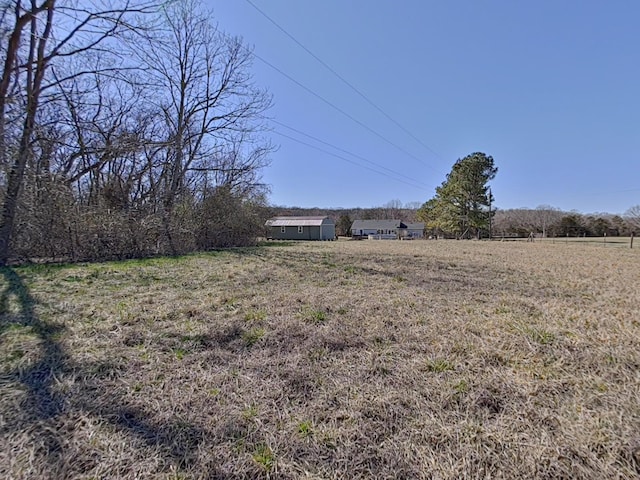 view of yard with a rural view