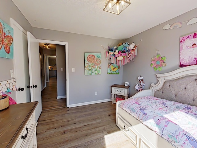 bedroom with light wood-type flooring and baseboards