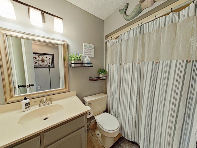 full bathroom with a textured ceiling, vanity, and toilet