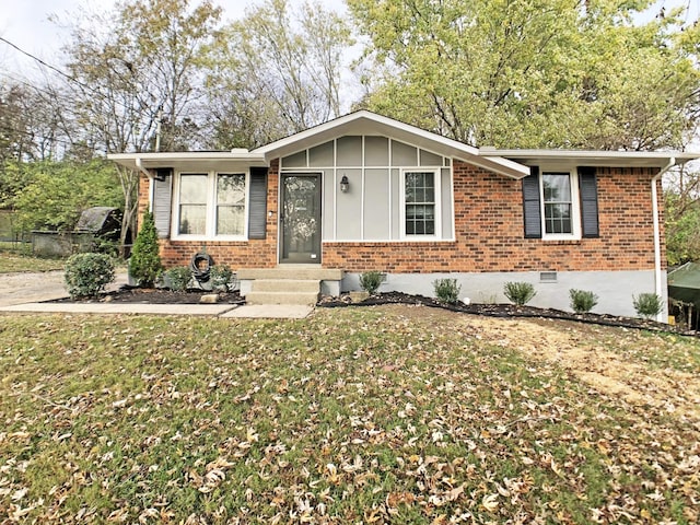 ranch-style home with board and batten siding, a front yard, crawl space, and brick siding