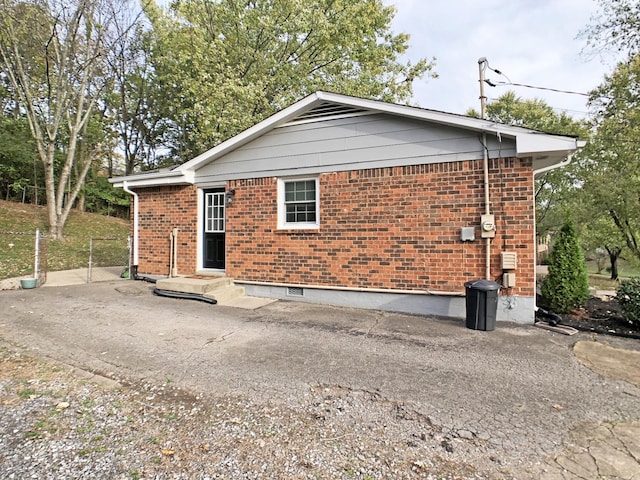 rear view of house featuring brick siding