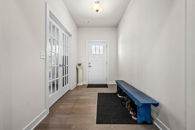 entryway with visible vents, baseboards, and wood finished floors