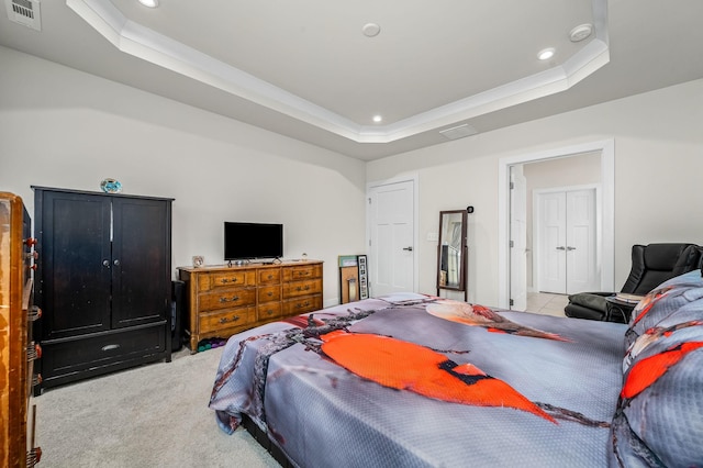 carpeted bedroom featuring visible vents, a raised ceiling, and recessed lighting