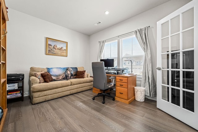 office featuring visible vents and wood finished floors